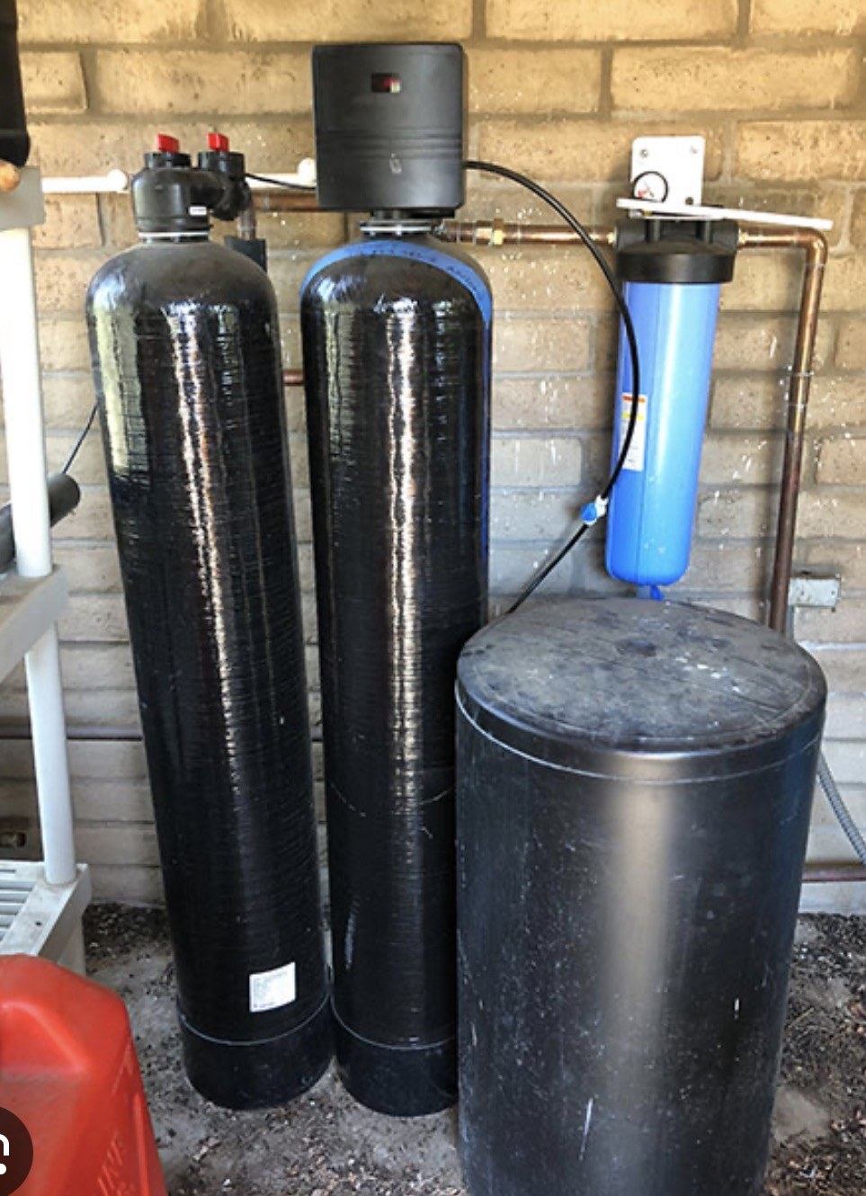 Three-stage whole-house water filtration system installed on a residential main water line